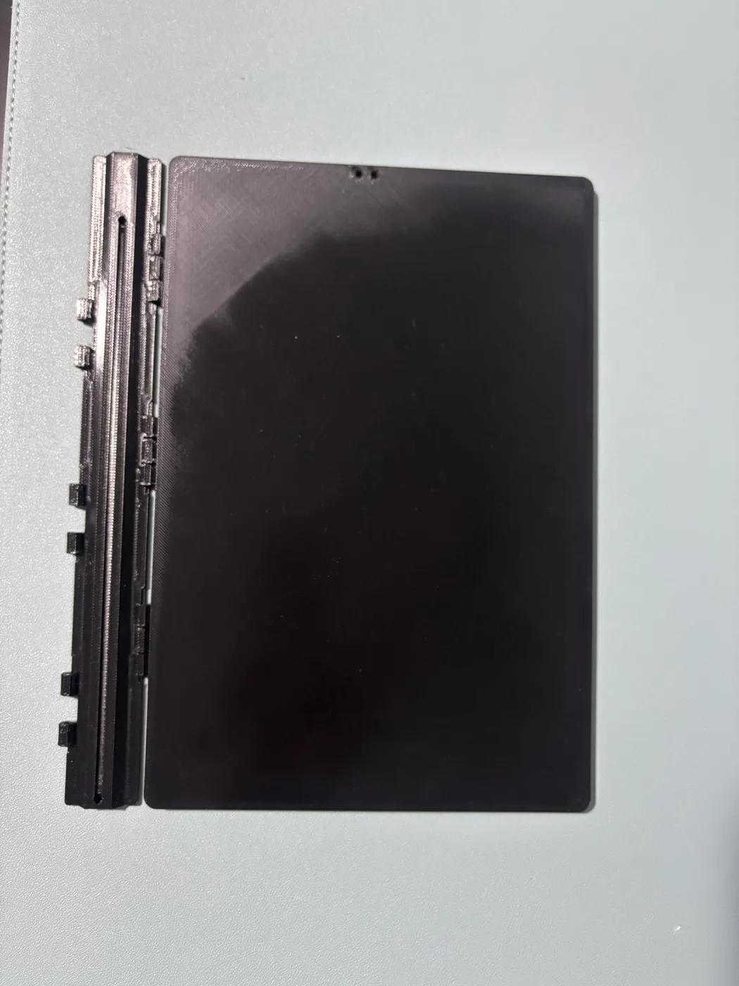 Printed black cover beside a full-length spine.